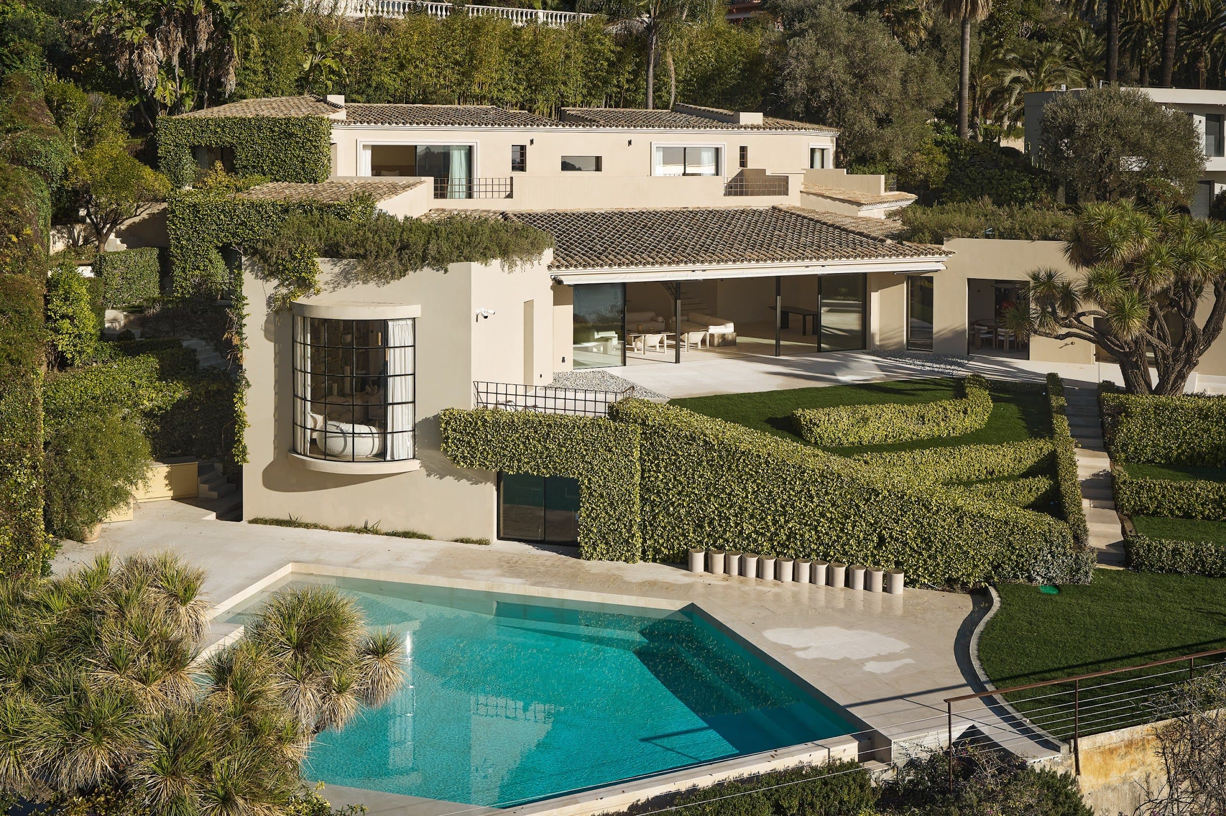 Aerial view of Villa Belvédère, pool and terraced gardens above the bay