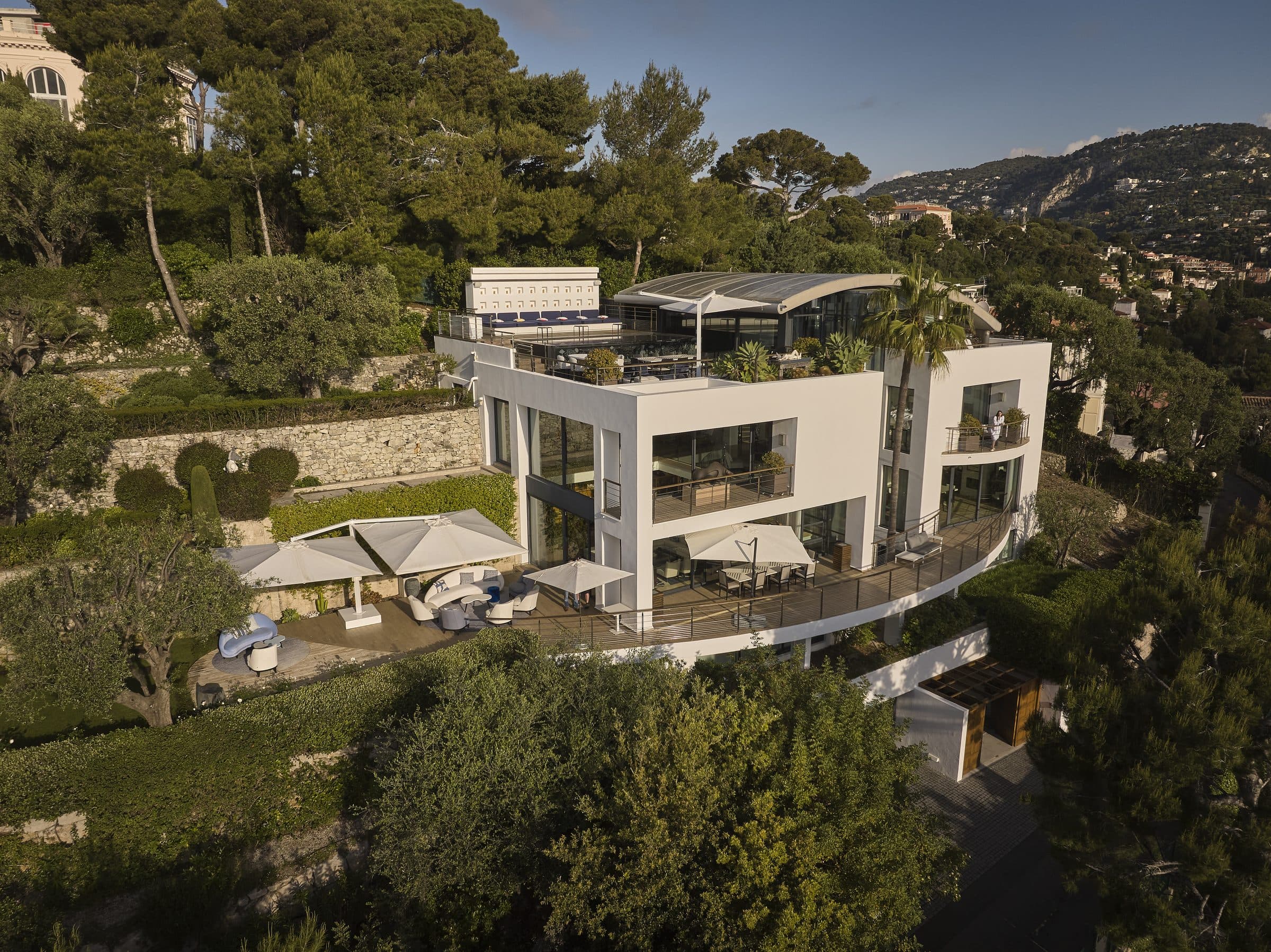 Villa Céleste white façade over five levels, among pines and olive trees
