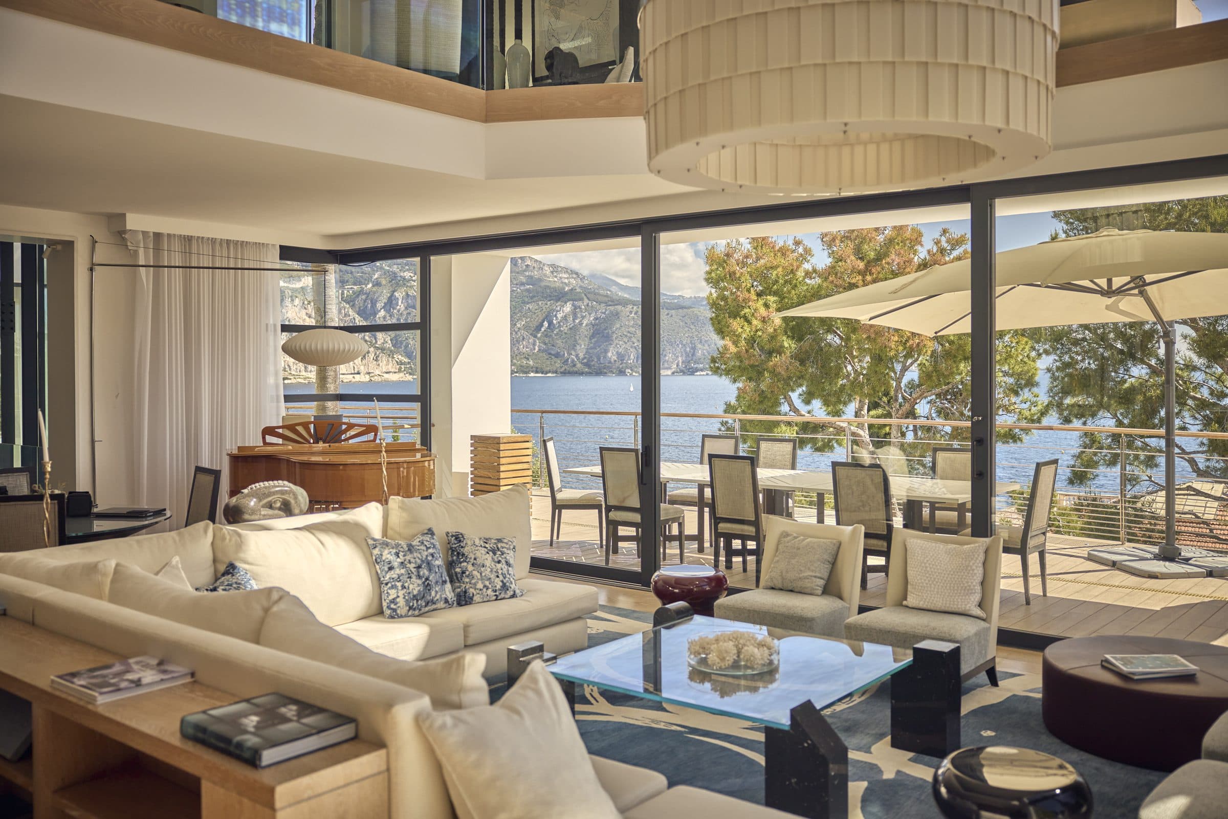 Villa Céleste double-height living room, floor-to-ceiling windows onto the sea