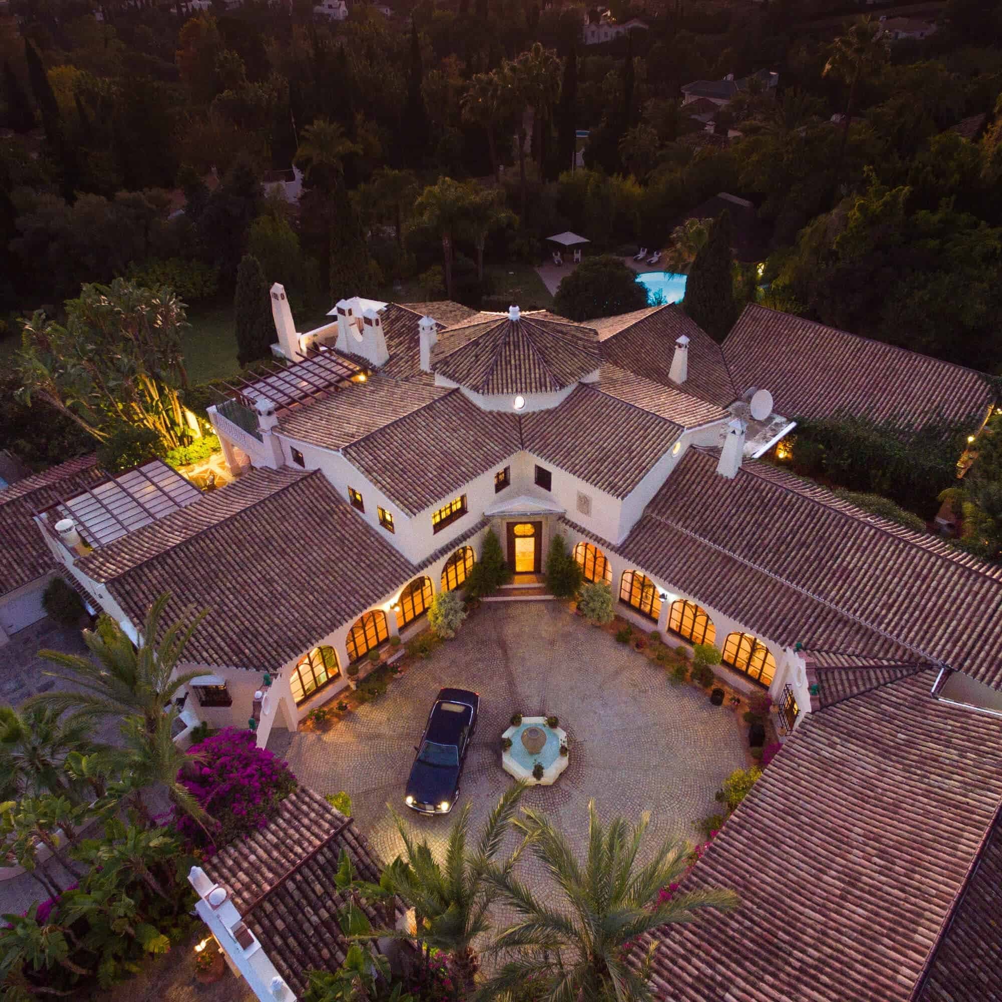 Aerial night view of Villa Azahar, its courtyard and fountain