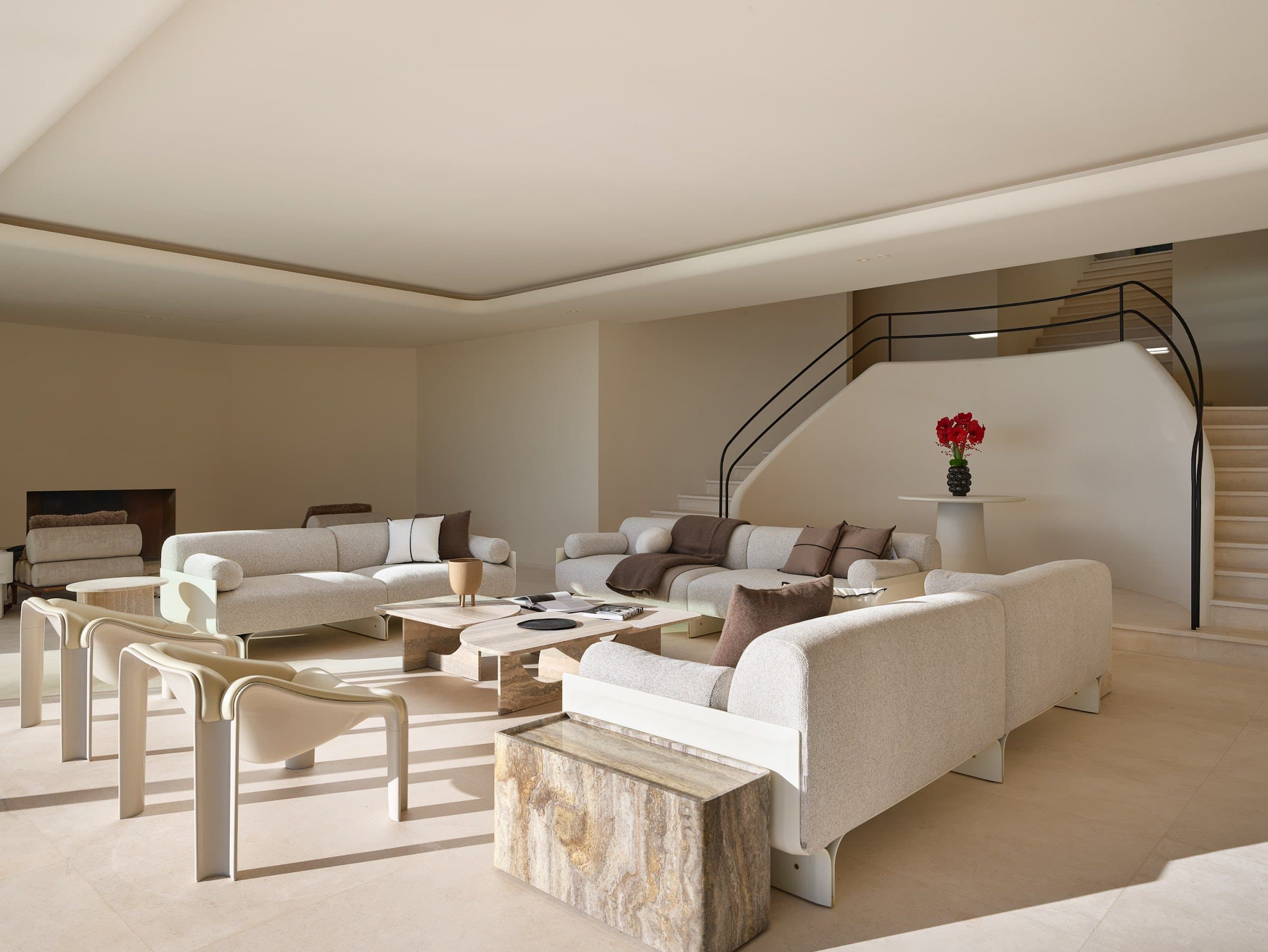Living space in one of our villas, sculptural staircase and sand tones